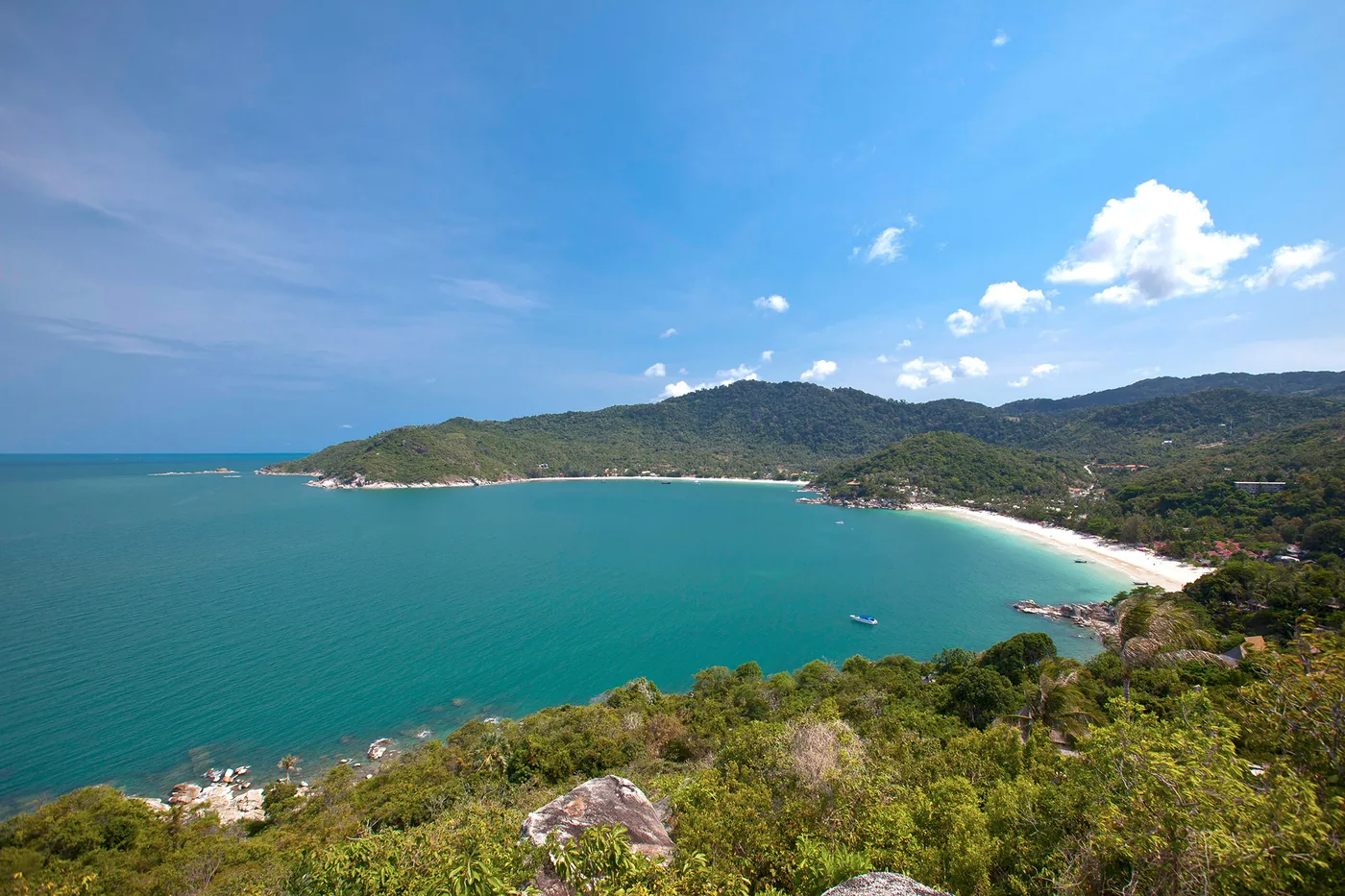 Thong Nai Pan Noi beach with red parasols, luxury resort backdrop