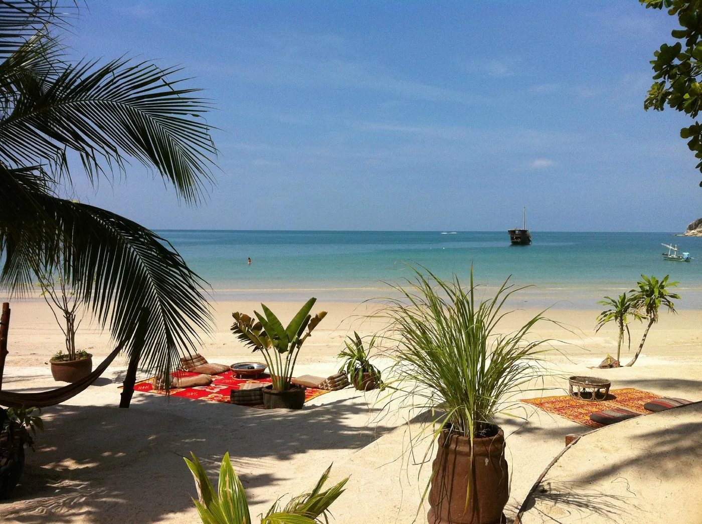 Beach cushions and plants in the shade, looking out to Thong Nai Pan sea