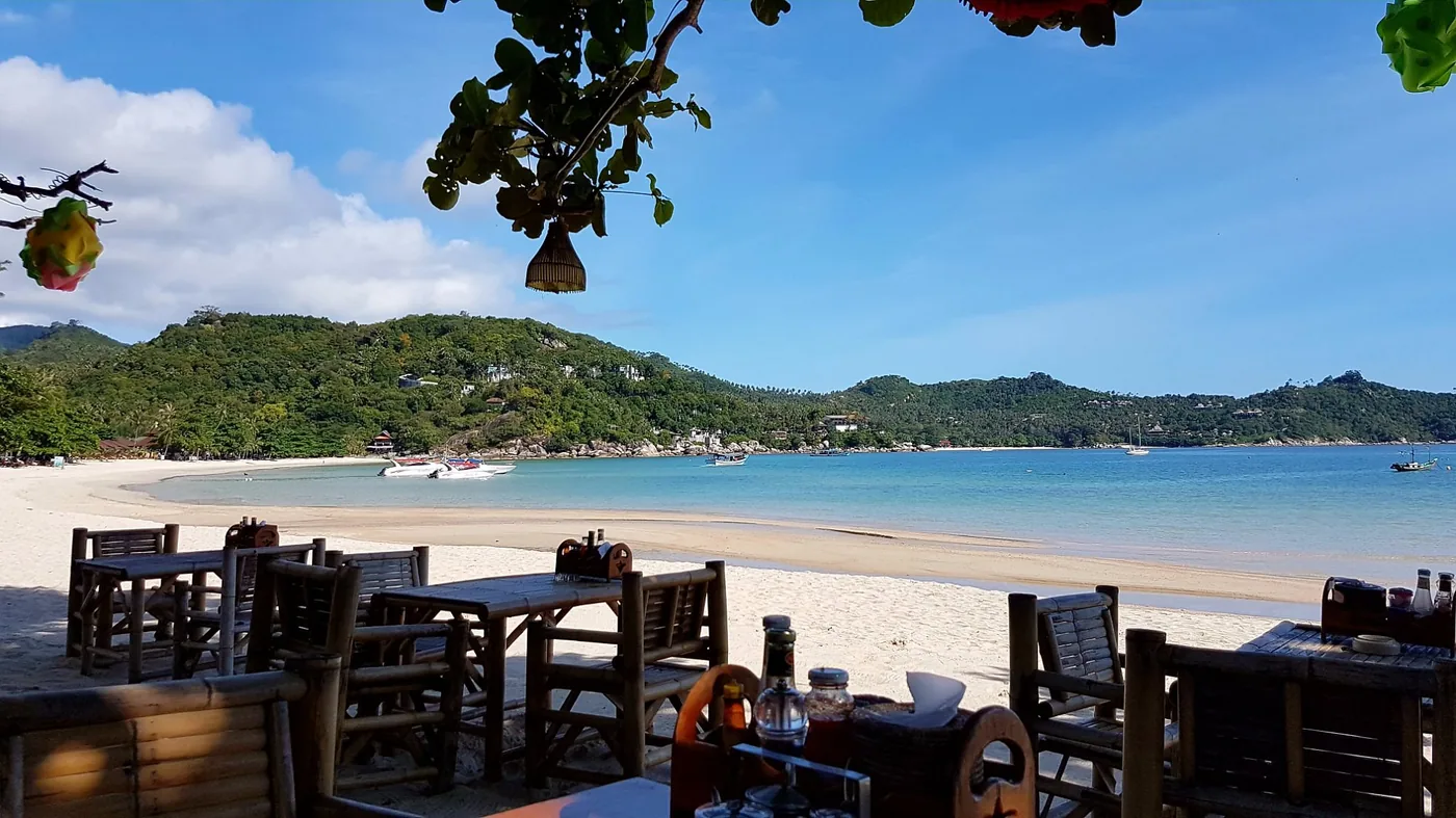 Beachside dining under trees, view over Thong Nai Pan bay, Koh Phangan